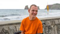 disabled person in a wheelchair by the beach, having fun in summer.